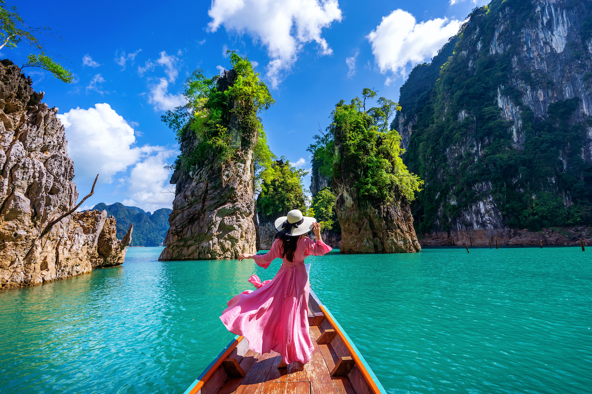 Beautiful,Girl,Standing,On,The,Boat,And,Looking,To,Mountains Woman standing on the boat